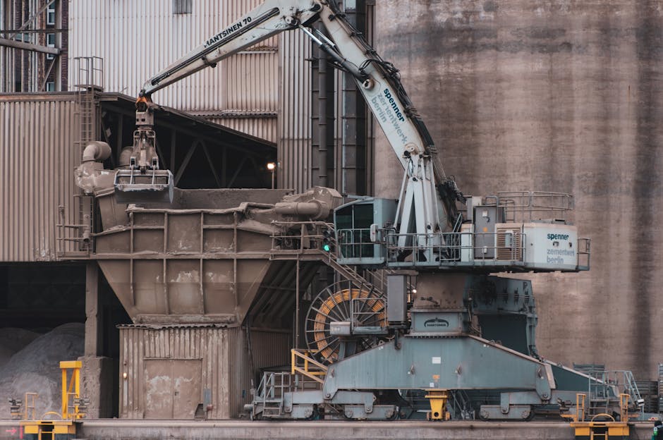 Large industrial crane used in cement factory highlighting heavy machinery operations.