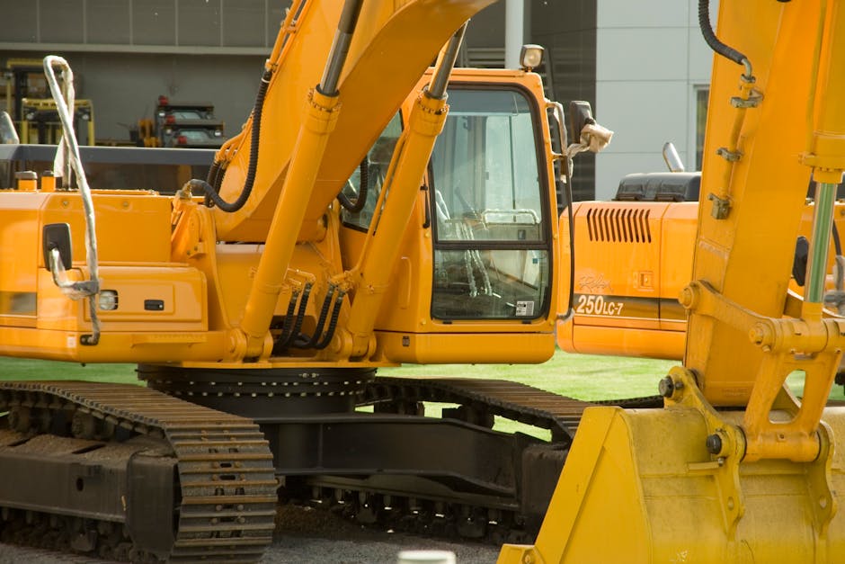 Close-up of yellow excavators at a construction site, showcasing industrial machinery and engineering.
